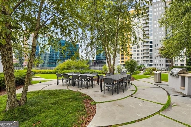 950 W Peachtree St NW Unit 1613, Atlanta, GA 30309 - view of property's community with a patio, a lawn, and area for grilling