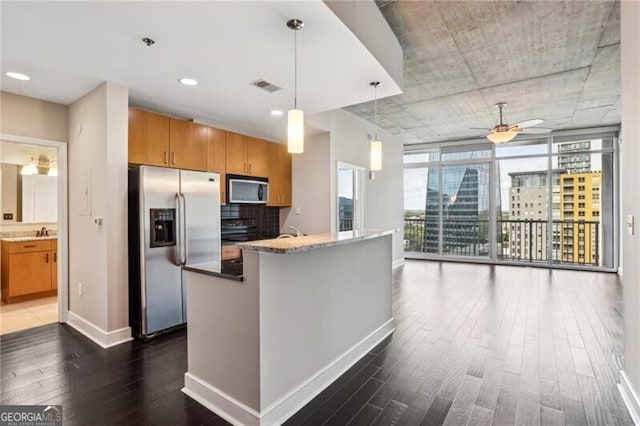 950 W Peachtree St NW Unit 1613, Atlanta, GA 30309 - kitchen with stainless steel appliances, dark wood-type flooring, baseboards, a ceiling fan, and brown cabinets