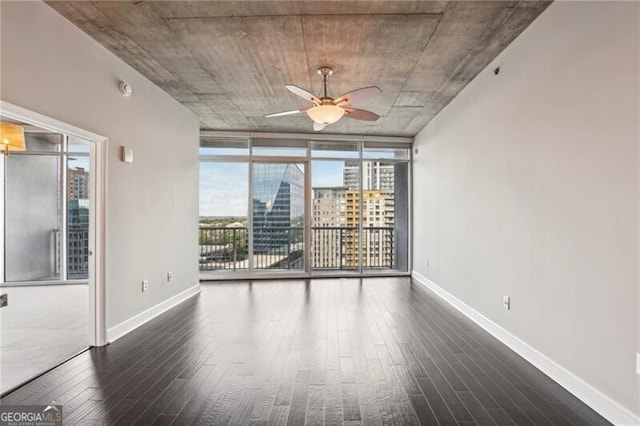 950 W Peachtree St NW Unit 1613, Atlanta, GA 30309 - unfurnished room featuring wood finished floors, a ceiling fan, a wall of windows, and baseboards