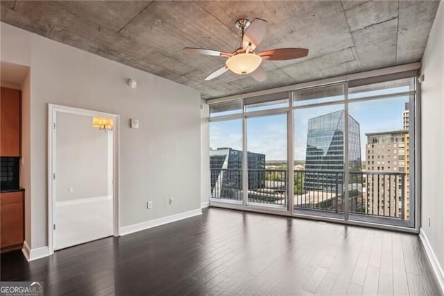 950 W Peachtree St NW Unit 1613, Atlanta, GA 30309 - empty room featuring expansive windows, wood finished floors, ceiling fan, baseboards, and a view of city