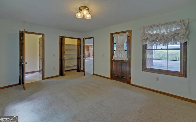 unfurnished bedroom featuring carpet and baseboards