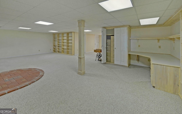 finished basement with carpet flooring and a paneled ceiling