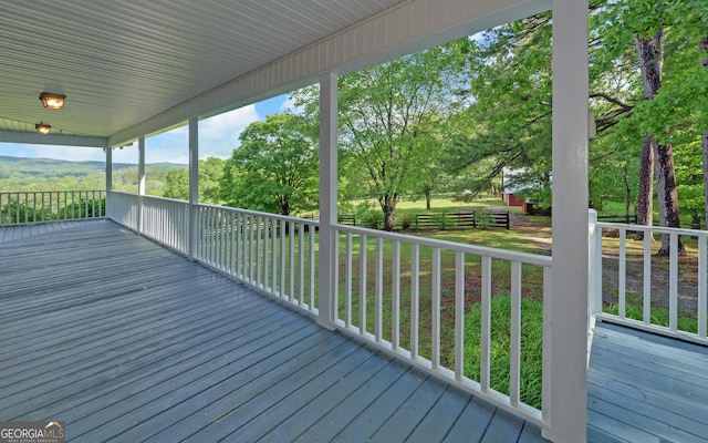 wooden deck featuring a yard