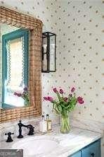 bar with a sink and wallpapered walls