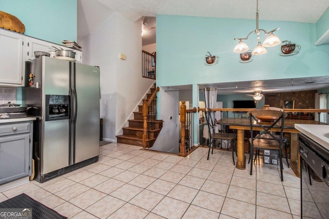 kitchen featuring stainless steel fridge with ice dispenser, black dishwasher, a chandelier, light tile patterned floors, and backsplash