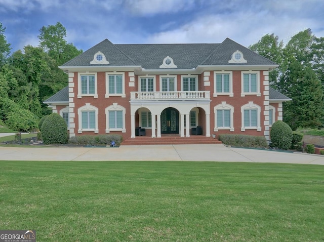 205 Somerset Ct, Mcdonough, GA 30253 - colonial-style house with a porch, a balcony, a front yard, and roof with shingles