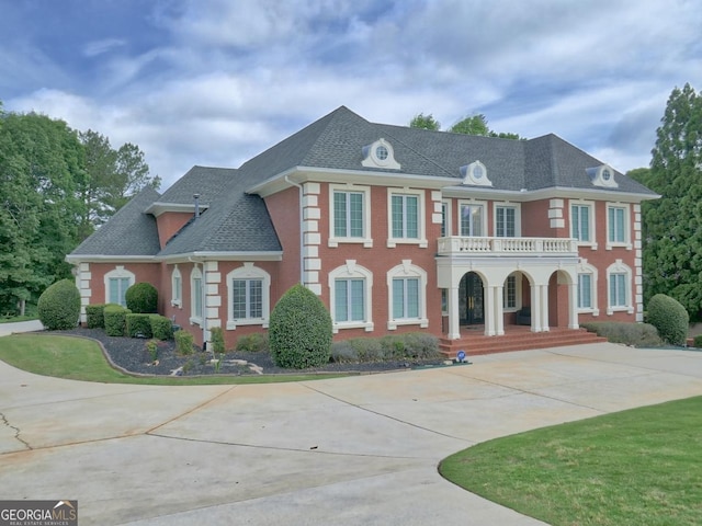 205 Somerset Ct, Mcdonough, GA 30253 - colonial inspired home with a porch, a balcony, driveway, and roof with shingles