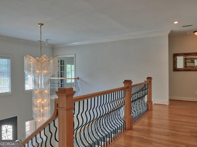 205 Somerset Ct, Mcdonough, GA 30253 - hall featuring a chandelier, an upstairs landing, wood finished floors, crown molding, and baseboards