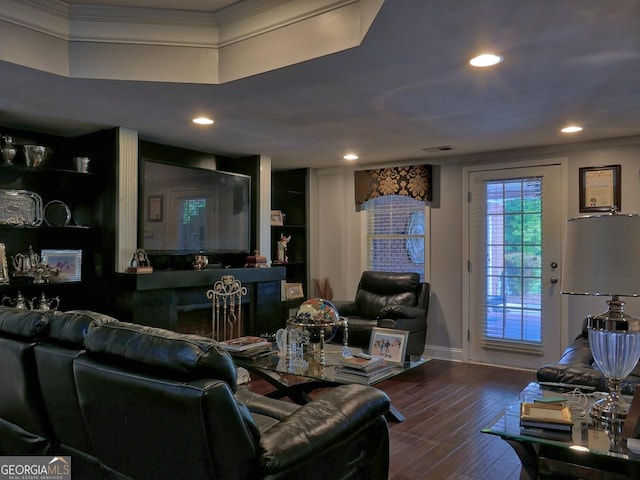 205 Somerset Ct, Mcdonough, GA 30253 - living room featuring crown molding, recessed lighting, dark wood-style flooring, baseboards, and built in shelves