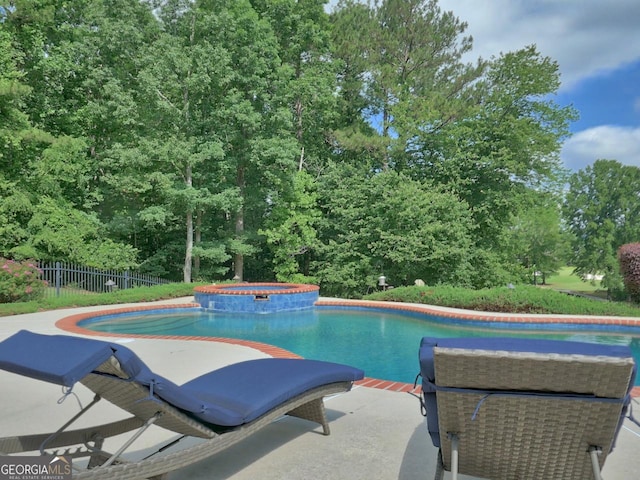 205 Somerset Ct, Mcdonough, GA 30253 - view of swimming pool with a patio, a pool with connected hot tub, and view of wooded area