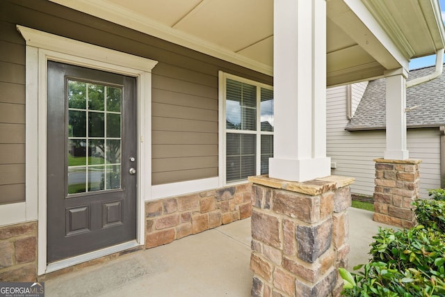 3805 Alden Pl, Cumming, GA 30028 - property entrance with covered porch, stone siding, and a shingled roof