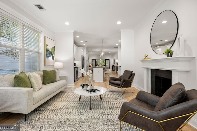 770 Ormewood Ave SE, Atlanta, GA 30312 - living room featuring light wood finished floors, recessed lighting, baseboards, a fireplace, and ornamental molding