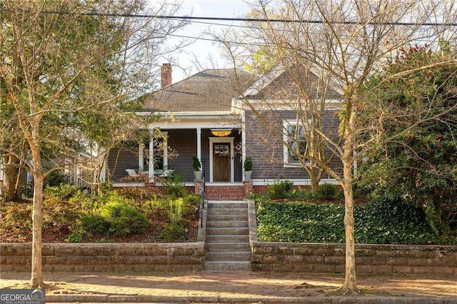 629 Hansell St SE, Atlanta, GA 30312 - view of front facade featuring covered porch, a chimney, and brick siding