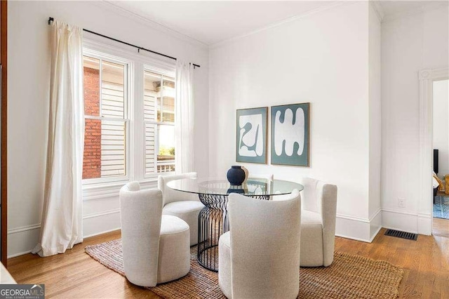 629 Hansell St SE, Atlanta, GA 30312 - dining area with wood finished floors, crown molding, and baseboards