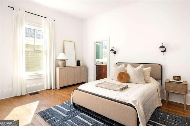 629 Hansell St SE, Atlanta, GA 30312 - bedroom with radiator heating unit, wood finished floors, and crown molding