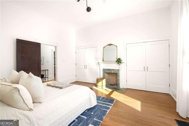 629 Hansell St SE, Atlanta, GA 30312 - bedroom featuring a premium fireplace, wood finished floors, baseboards, and multiple closets