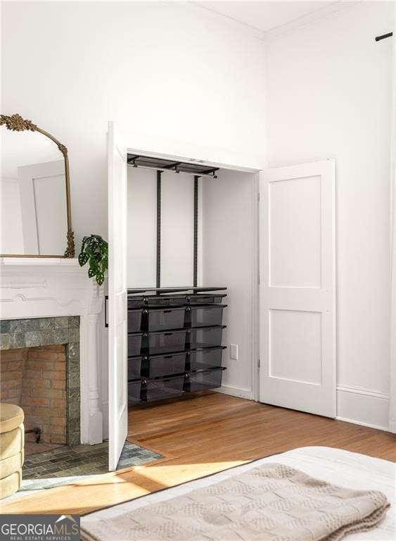 629 Hansell St SE, Atlanta, GA 30312 - bedroom with wood finished floors, a tile fireplace, and baseboards