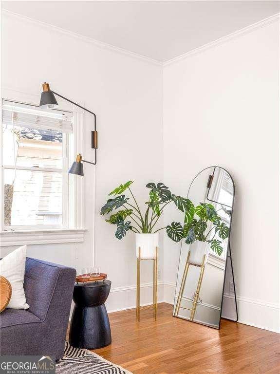 629 Hansell St SE, Atlanta, GA 30312 - living area featuring wood finished floors, crown molding, and baseboards