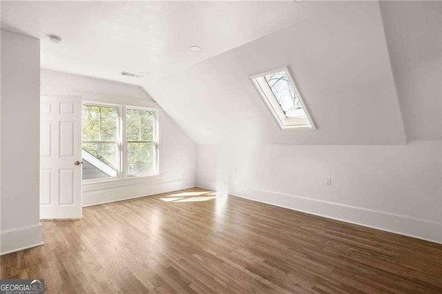 629 Hansell St SE, Atlanta, GA 30312 - additional living space featuring a skylight, wood finished floors, baseboards, and vaulted ceiling