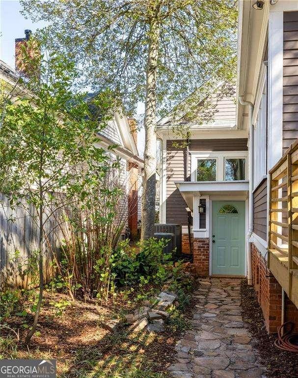 629 Hansell St SE, Atlanta, GA 30312 - entrance to property featuring fence, central AC unit, and brick siding