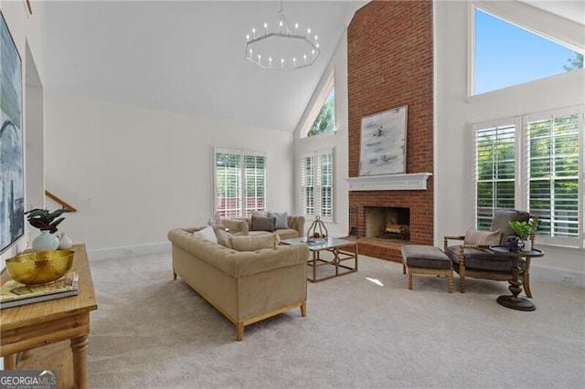 carpeted living area featuring high vaulted ceiling, a fireplace, plenty of natural light, a chandelier, and baseboards
