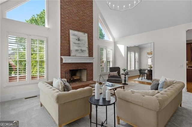 living area featuring high vaulted ceiling, healthy amount of natural light, and a fireplace