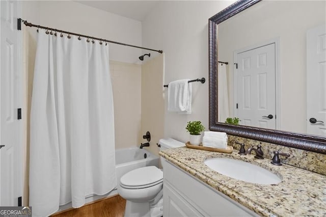 full bath with toilet, vanity, shower / bath combination with curtain, and wood finished floors