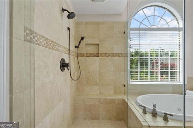 full bathroom with tiled shower, healthy amount of natural light, and a jetted tub