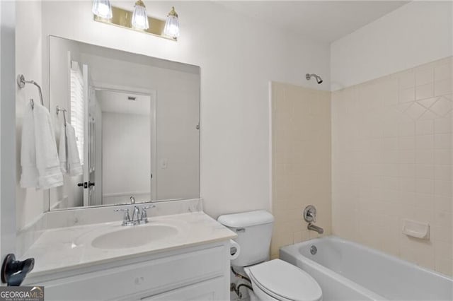 full bath featuring vanity, toilet, and washtub / shower combination