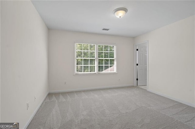 empty room with carpet floors and baseboards