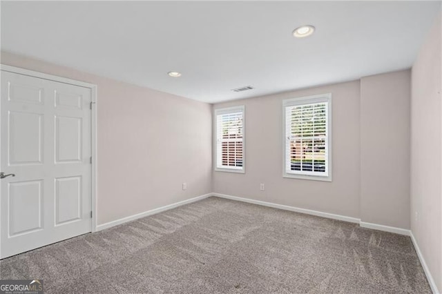 unfurnished bedroom with carpet flooring, baseboards, and recessed lighting