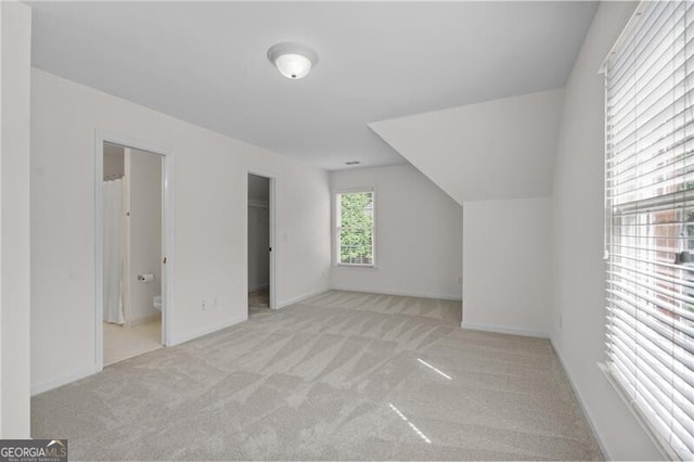 bonus room with carpet and baseboards