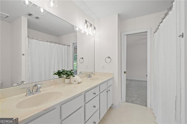 bathroom with double vanity and tile patterned flooring