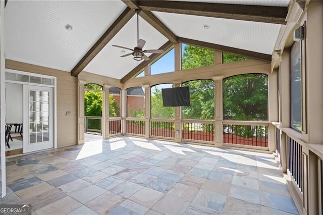 unfurnished sunroom featuring a ceiling fan