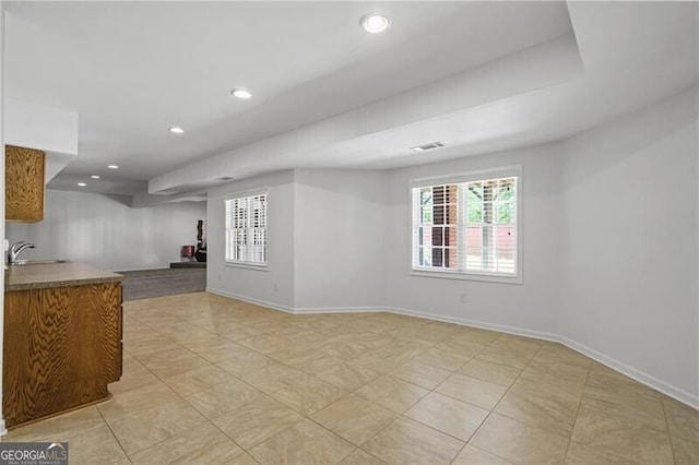 spare room featuring a sink, baseboards, recessed lighting, and light tile patterned flooring
