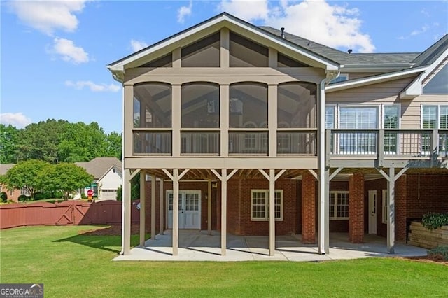 rear view of property with a sunroom and a patio area