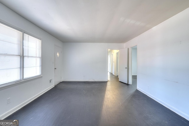 707 E Spring St, Monroe, GA 30655 - empty room with dark wood-style floors and baseboards
