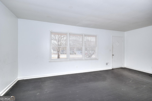 707 E Spring St, Monroe, GA 30655 - spare room with dark wood finished floors and baseboards