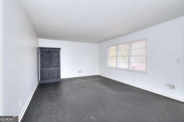 707 E Spring St, Monroe, GA 30655 - spare room featuring baseboards and dark wood finished floors