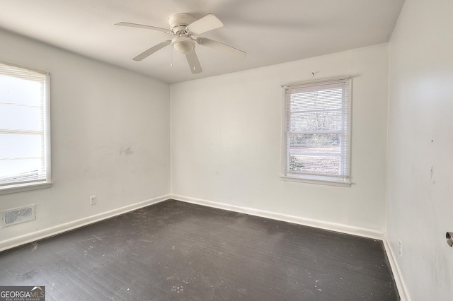 707 E Spring St, Monroe, GA 30655 - unfurnished room with dark wood-style flooring, healthy amount of natural light, baseboards, and ceiling fan
