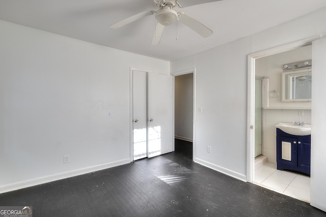 707 E Spring St, Monroe, GA 30655 - unfurnished bedroom featuring a sink, ensuite bathroom, hardwood / wood-style floors, and baseboards
