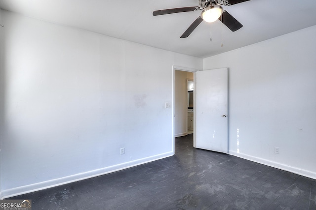 707 E Spring St, Monroe, GA 30655 - unfurnished room with baseboards, a ceiling fan, and dark wood-style floors
