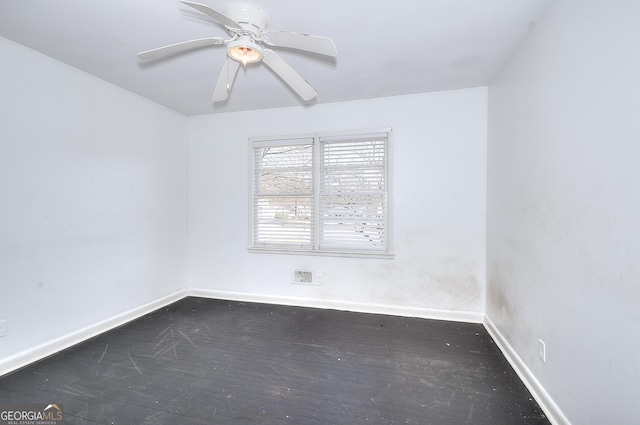 707 E Spring St, Monroe, GA 30655 - spare room with baseboards, dark wood-type flooring, and a ceiling fan