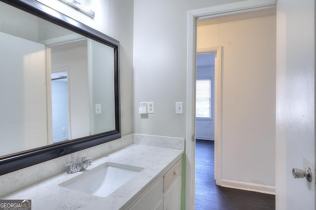 707 E Spring St, Monroe, GA 30655 - bathroom featuring wood finished floors, vanity, and baseboards