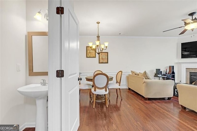 5711 Keys Way, Lithonia, GA 30058 - living room with crown molding, wood finished floors, a tile fireplace, a chandelier, and a ceiling fan