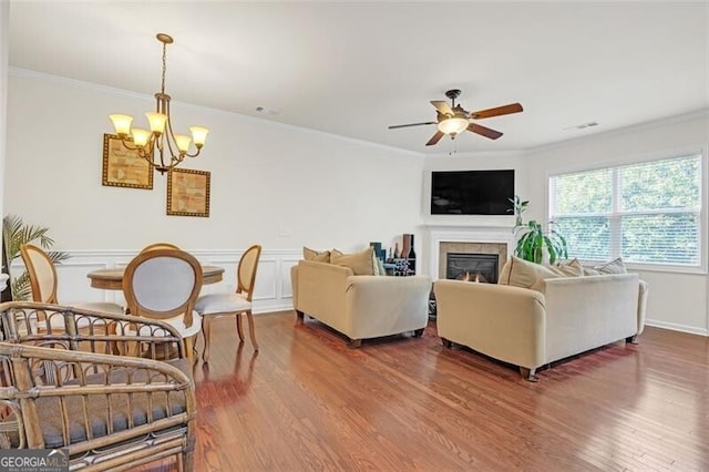 5711 Keys Way, Lithonia, GA 30058 - living area with wood finished floors, ceiling fan, a chandelier, crown molding, and a tile fireplace