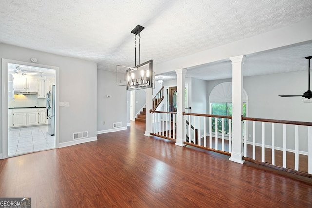 175 River Run, Roswell, GA 30075 - unfurnished room featuring wood finished floors, a ceiling fan, a textured ceiling, baseboards, and ornate columns