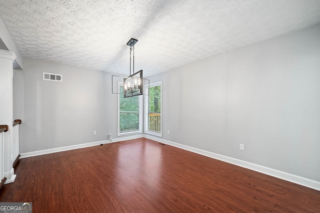 175 River Run, Roswell, GA 30075 - spare room with dark wood finished floors, a chandelier, and baseboards
