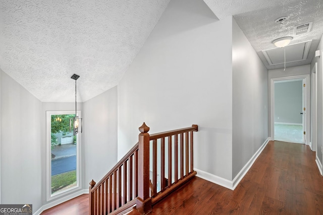 175 River Run, Roswell, GA 30075 - hallway featuring attic access, a textured ceiling, an upstairs landing, wood finished floors, and baseboards