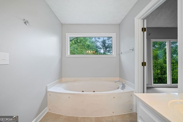 175 River Run, Roswell, GA 30075 - full bath with a whirlpool tub, vanity, a textured ceiling, tile patterned flooring, and baseboards